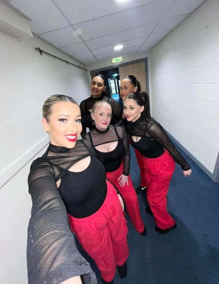 All performers on stage celebrating after annual dance show